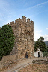 Fototapeta na wymiar Tower of the church of San Sebastian the mountain. Selva de Mar, Girona, Spain. Romanesque style. Next door is the village cemetery.