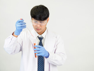 Asian male student scientist in reagent mixing laboratory In a science research laboratory with...