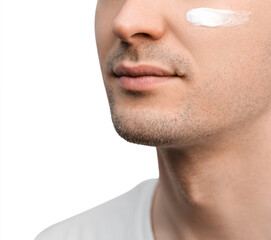 Fototapeta premium A portrait of a handsome man with a stubble in a white t-shirt, sample of a face cream on his cheek.