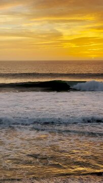 Beach sunset in vibrant yellow along the coast in Laguna Beach