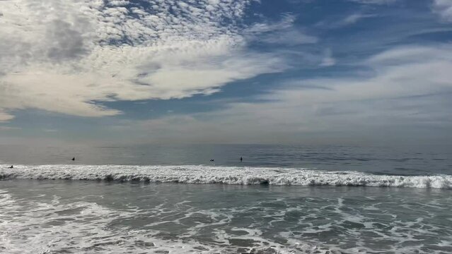 Surfers, waves and big blue sky in Laguna Beach