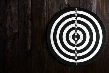 Dartboard isolated on a wooden background. Copy space. Money.Darts game.Business concept.Successful game.National English game. Target on a wooden background.