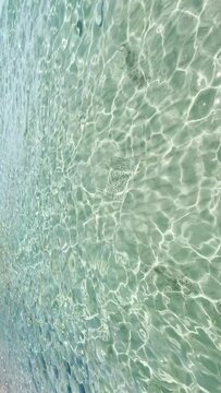 Abstract ocean waves and reflections rippling over sand