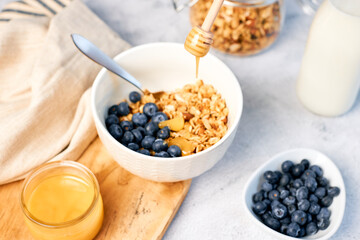 Fresh fragrant homemade granola made from oatmeal, honey, nuts and fresh blueberries. Balanced breakfast or snack.