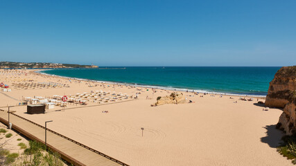 Fototapeta na wymiar Beautiful view of the Praia da Rocha and boardwalk along the beach. Portimao, Portugal