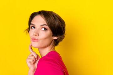 Profile side photo of pretty dreamy lady wear stylish clothes interested look empty space isolated on yellow color background