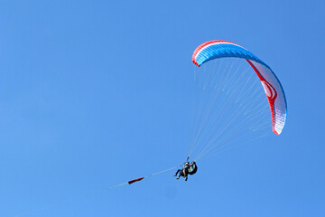 Tandem Paraglider being towed by a winch	