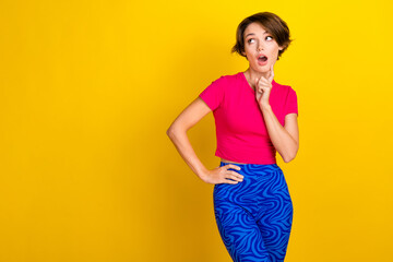 Photo of pretty impressed lady wear pink t-shirt open mouth hand arm chin looking empty space isolated yellow color background
