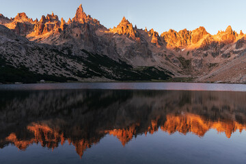 Fototapeta na wymiar Sunrise reflection on lake landscape over refugio frey in Argentina 