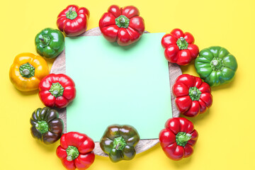 Composition with fresh bell peppers and blank sheet of paper on yellow background