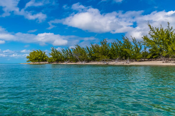 A view from the sea along a deserted bay on the island of Eleuthera, Bahamas on a bright sunny day