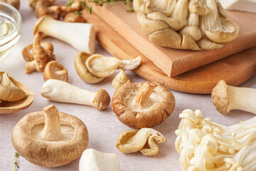 Fototapeta na wymiar Fresh raw mushrooms on light table, closeup