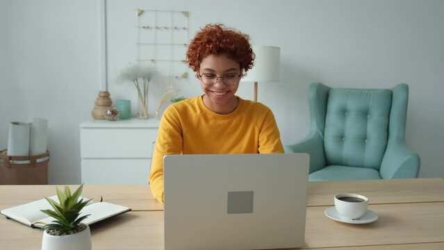 African American Girl Using Laptop At Home Office Looking At Screen Typing Chatting Reading Writing Email. Young Woman Having Virtual Meeting Online Chat Video Call Conference. Work Learning From Home