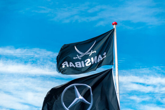 Mercedes Benz flag and Zanzibar flag in black on Sylt on the beach in front of the bar