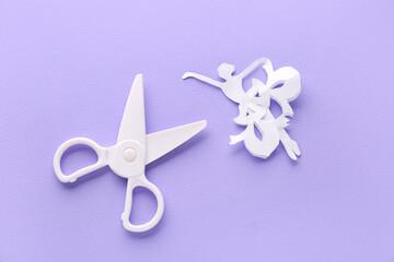 Scissors and paper decor on lilac background