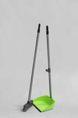 Dustpan with cleaning broom on white background