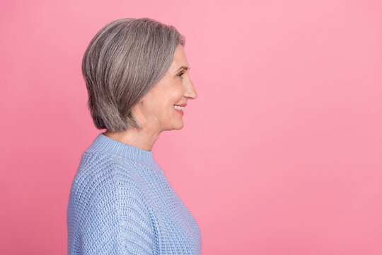 Side Profile Photo Of Mature Aged Old Senior Cheerful Grandmother Woman Gray Hair Smiling Looking Empty Space Ad Isolated On Pink Color Background