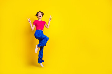 Fototapeta na wymiar Full length photo of overjoyed positive lady wear stylish clothes arm demonstrate v-sign empty space isolated on yellow color background