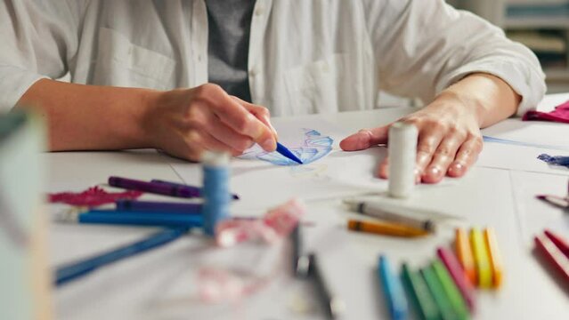 Design studio for creative people. Young girl working at workplace Dress is colorful. Close-up Tailor Actively working in a salon with work environment, Modern things
