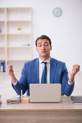 Young male employee working in the office