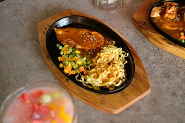 Close-up of a bowl of soba noodles with sliced roast beef steak. Asian cuisine