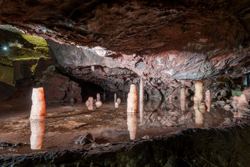 Stalagmites in a rock pool inside Goughs Cave in Cheddar