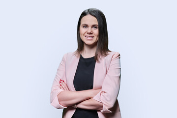 Confident business young female looking at camera on white background