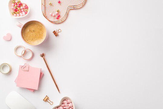Valentine's Day concept. Top view photo of workspace stationery holder sticky note paper pushpins binder clips adhesive tape saucer sprinkles cup of coffee on isolated white background with copyspace