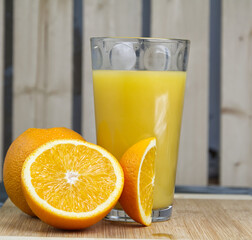 Glass of oragne juice on wood