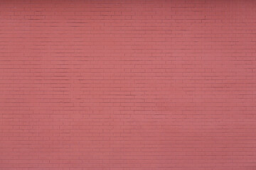 Fototapeta premium Red brick wall texture. Decorative plaster imitating brickwork. Background with plastered and painted wall.