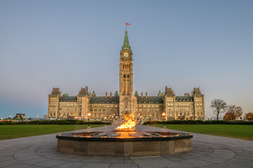 Parliament of Canada Peace Tower with Centennial Flame in foreground in early morning