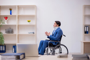 Young male employee after car accident at workplace