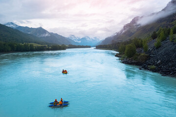 Team extreme rafting on red boat on stormy blue river Altai, Aerial top view. Concept adventure...