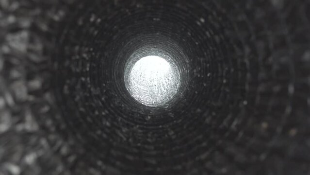 Moving in direction of bright light at the end of metallic tunnel.