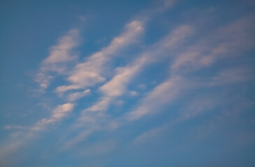 Minimalistic sky with cirrus clouds and clouds at sunset, evening cloudy sky