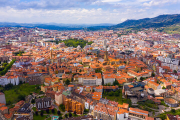 Fototapeta na wymiar View from drone of residential areas of Spanish city of Oviedo on background on summer mountain landscape ..