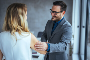Recruiter shaking successful smiling businesswoman candidate hand at meeting, congratulating with getting new job, manager making great deal with customer, diverse business partners greeting