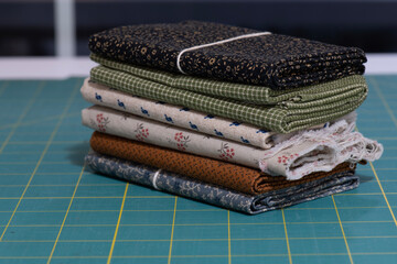 Stack of vintage quilting fabric on rotary mat