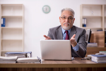Old male boss employee working in the office