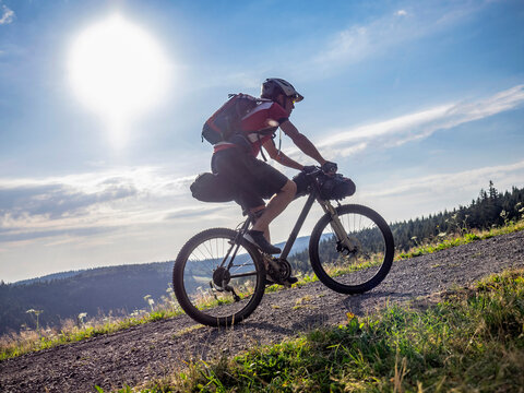 Mountain biker riding uphill near Todtnauberg, Baden-Württemberg, Germany