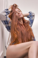 Fototapeta premium A girl who has just woken up stretches and wakes up on the stairs
