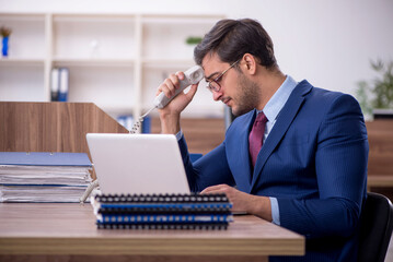 Young male employee working in the office