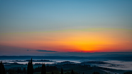 hazy sunrise over Tuscany