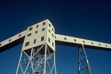 White grain elevator in urban shipping port.