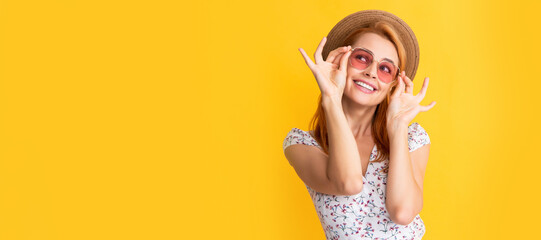 happy woman in straw hat and sunglasses on yellow. Woman isolated face portrait, banner with copy space background.