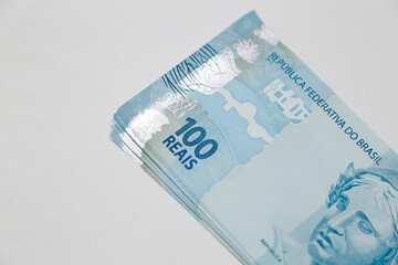 banknotes of one hundred reais on white background