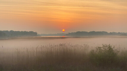 Obraz na płótnie Canvas sunrise over the marsh and lake