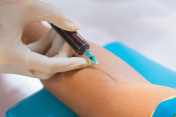 Nurse collecting a blood from patient in hospital