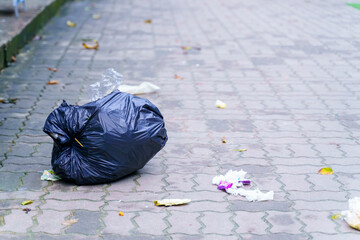 Spilled garbage on streets of big city with garbage sitting on the ground