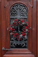 Beautiful Christmas wreath hanging on wooden door